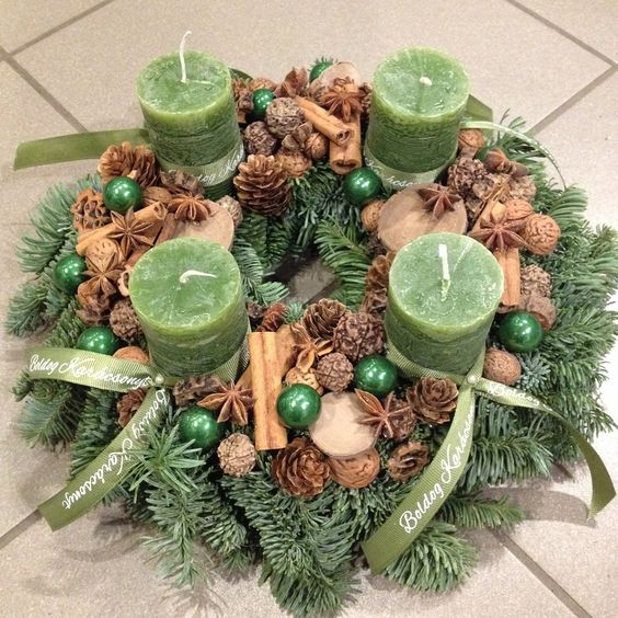 Vianočný veniec na stôl so zelenými sviečkami a šiškami