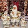 Vianočná dekorácia Santa Claus zlatý, má oblečený zlatý kabát so zlatým opaskom a v ruke drží darčeky