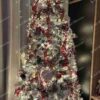 Umelý vianočný stromček Borovica Biela Úzka 225cm, stromček je husto zasnežený a je ozdobený červenými a bielymi ozdobami
