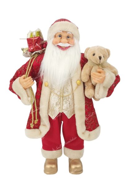 Dekorácia Santa Claus Červeno-Zlatý 60cm, má oblečený červený kabát so zaltými retazkami a zlatými ornamentmi a zlatou vestou. Na nohách má zlaté topánky a vrike drži plyšovú hračku